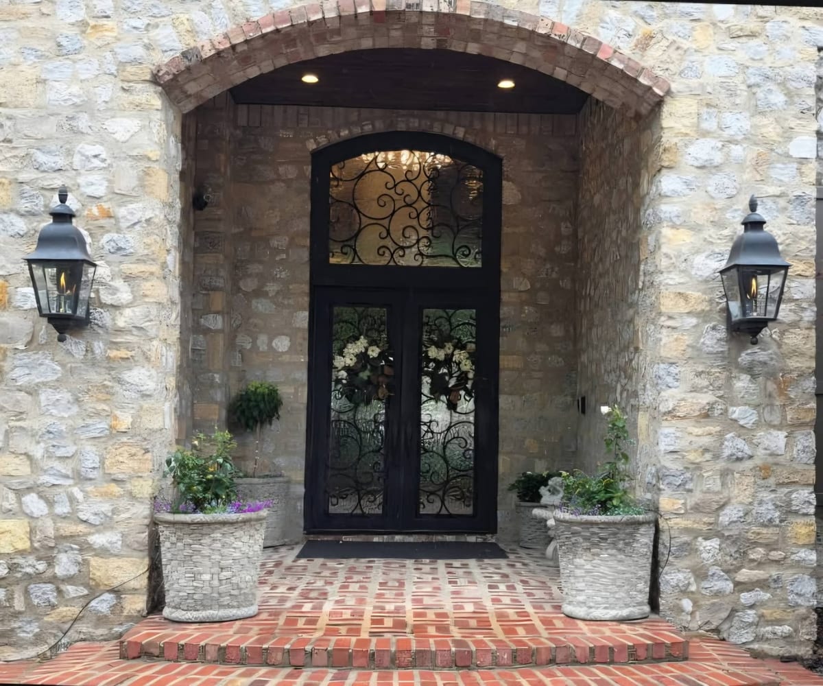 Natural gas entry lanterns mounted beside a front door