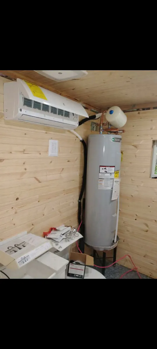 Ductless mini-split head mounted on an interior wall